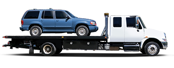 Tow truck towing a blue SUV